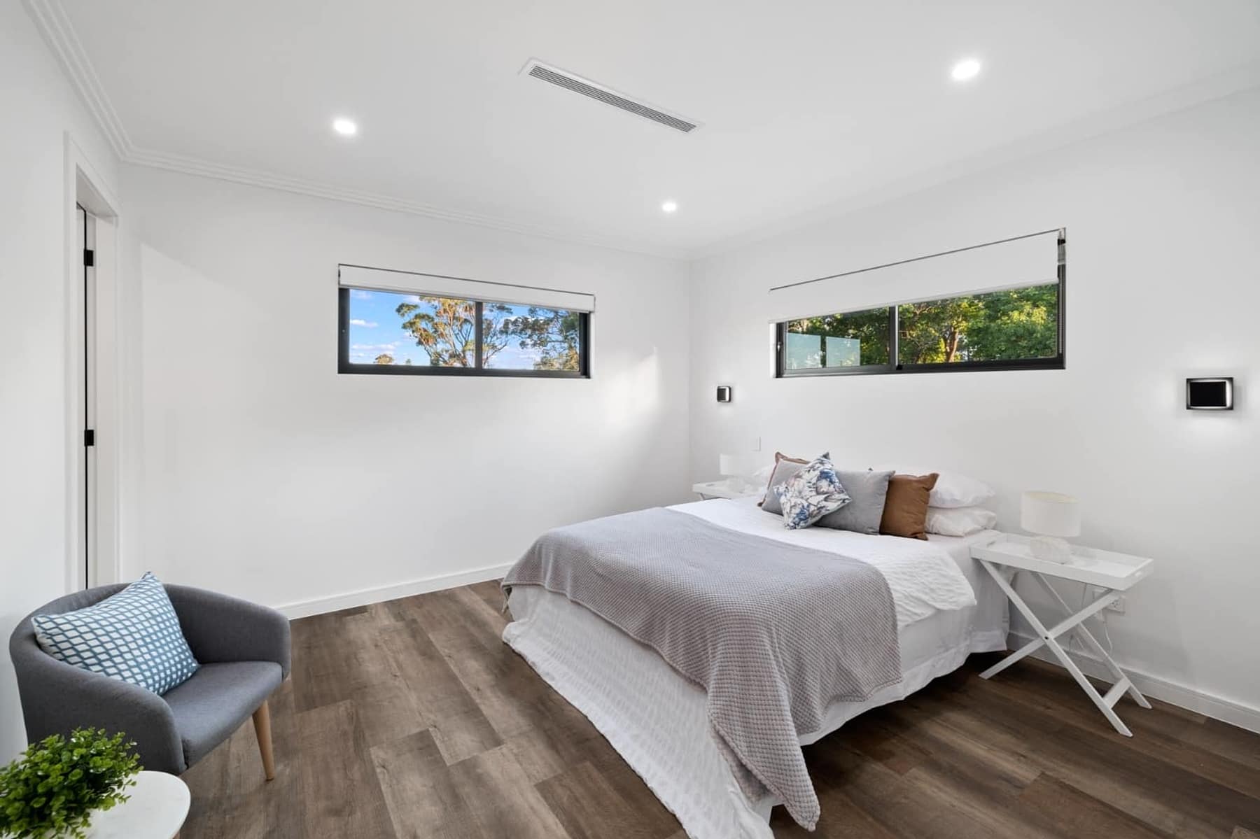 Master bedroom with highlight windows, timber floors and ensuite entry