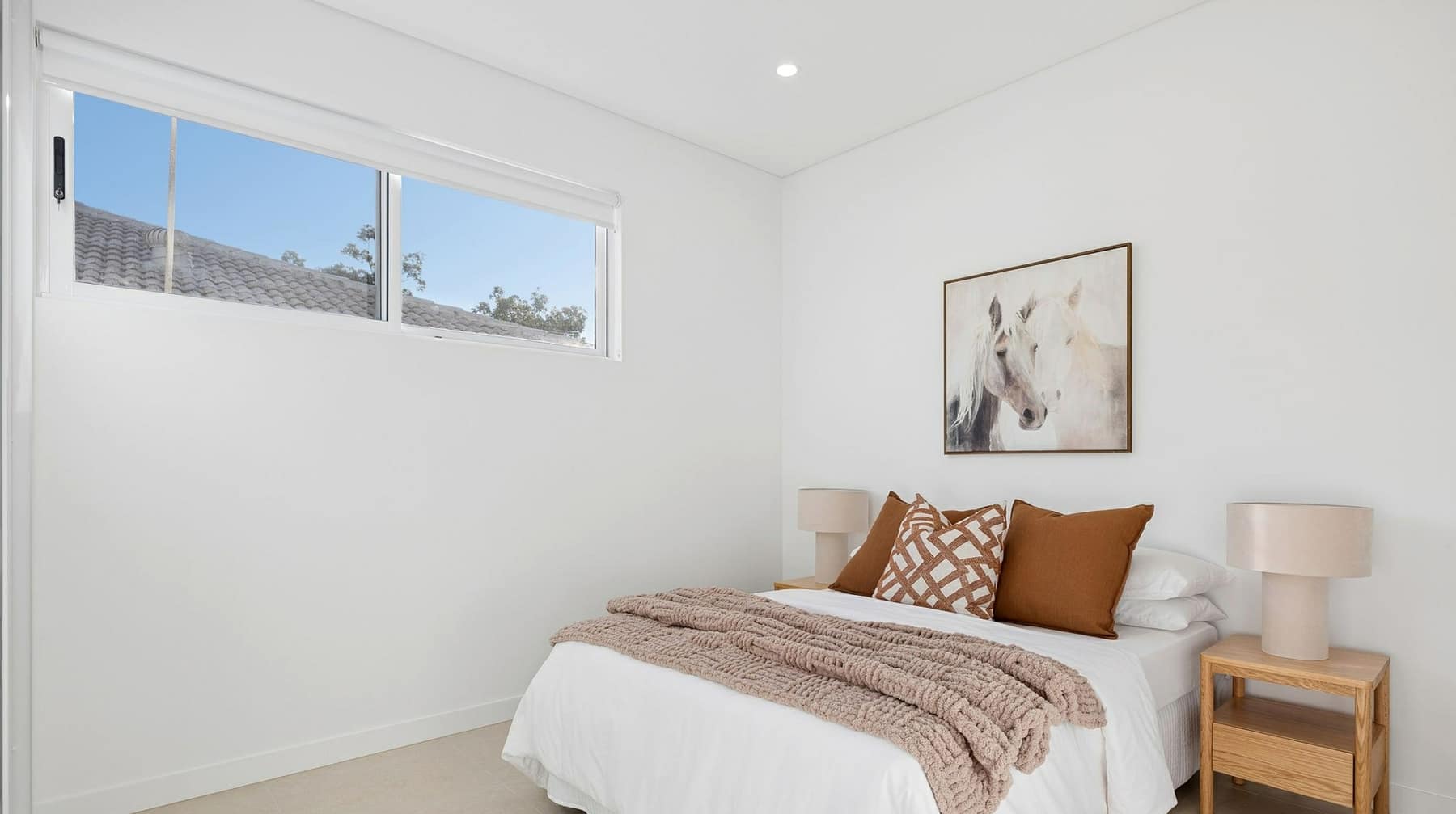 Twilight view of the four Carbine Close terraces in Casula, with ramped entries and twin balcony lines