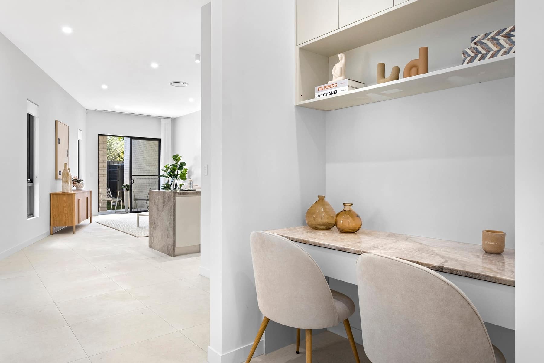 Built-in study nook with stone desk looking through to the open-plan living zone